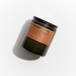 P.F. Candle Co. Wholesale - Bergamot Shiso 7.2 oz Alchemy Scented Soy Wax Candle - Product - Alchemy Candles feature smoke-colored glass vessels, black metal lids, and gold-leafed labels inspired by vintage window lettering.