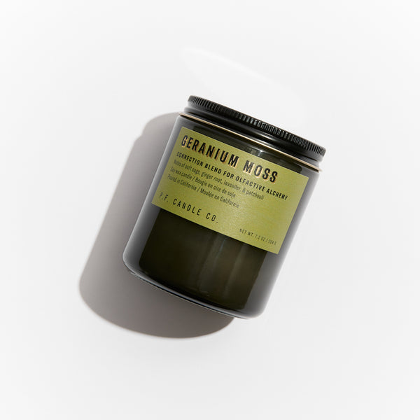P.F. Candle Co. Wholesale Geranium Moss Alchemy Candle - Product - Alchemy Candles feature smoke-colored glass vessels, black metal lids, and gold-leafed labels inspired by vintage window lettering.