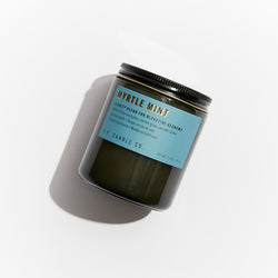 P.F. Candle Co. Wholesale Myrtle Mint Alchemy Candle - Product - Alchemy Candles feature smoke-colored glass vessels, black metal lids, and gold-leafed labels inspired by vintage window lettering.