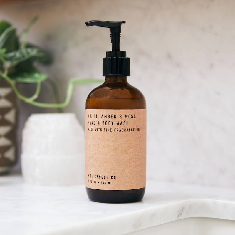 P.F. Candle Co. Wholesale Amber & Moss Hand & Body Wash - Lifestyle - Scent notes of sage, moss, and lavender. Inspired by a weekend in the mountains, sun gleaming through the canopy.