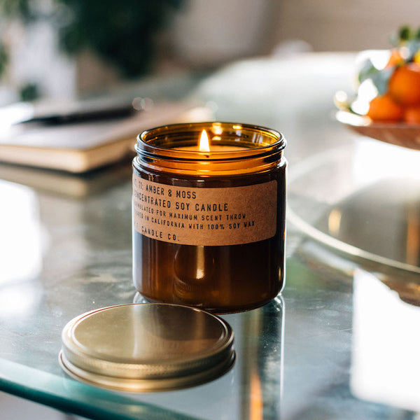 P.F. Candle Co. Wholesale Amber & Moss Large Concentrated Candle - Lifestyle - A weekend in the mountains, sun gleaming through the canopy. Notes of sage, moss, and lavender.