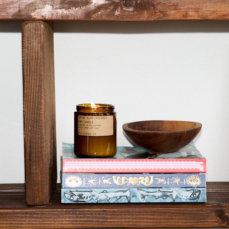 P.F. Candle Co. Wholesale Ojai Lavender Standard Candle - Lifestyle - A calming vortex surrounded by sun-drenched fields, orange groves and lavender farms, jagged mountains washed in a rosy, sunset glow. Aromatic, herbal, citrus. Notes of pixie tangerine, blue lavender, and coyote mint.