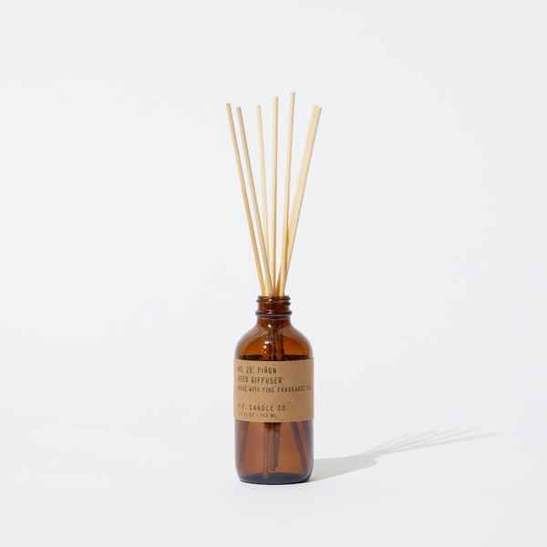 P.F. Candle Co. Wholesale Piñon Reed Diffuser - Product2 - Apothecary-inspired amber glass bottles with our signature kraft label and rattan reeds