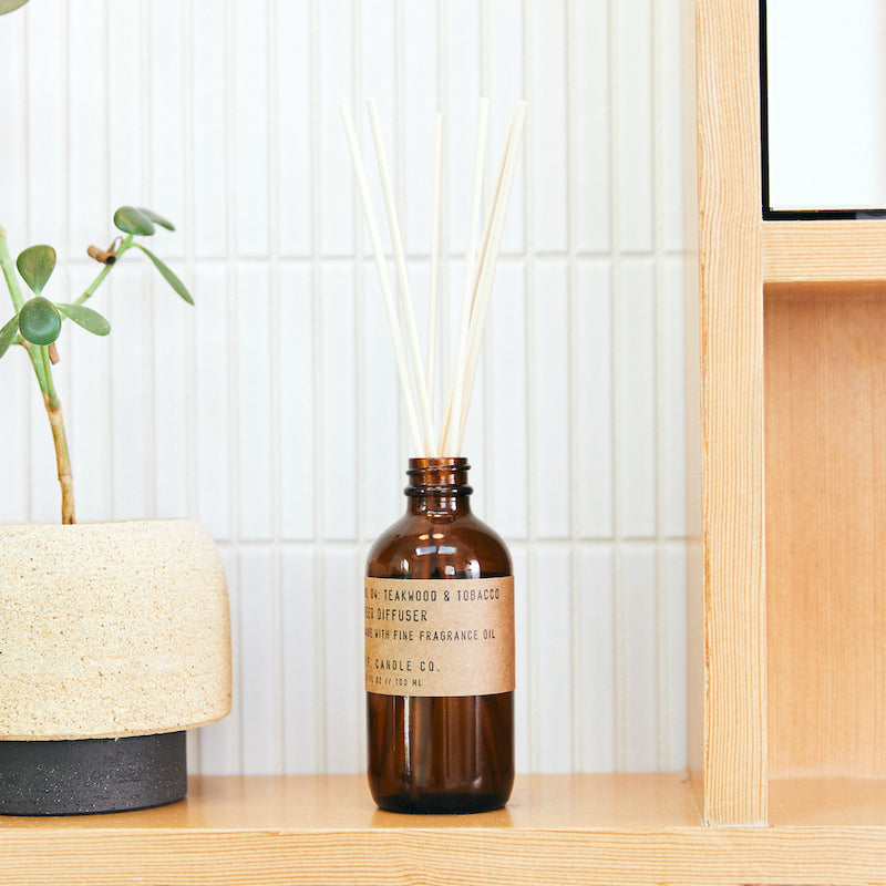 P.F. Candle Co. Wholesale Teakwood & Tobacco Reed Diffuser - Lifestyle - The one that started it all. Some call it the boyfriend scent, we call it the O.G. Leather, teak, and orange.