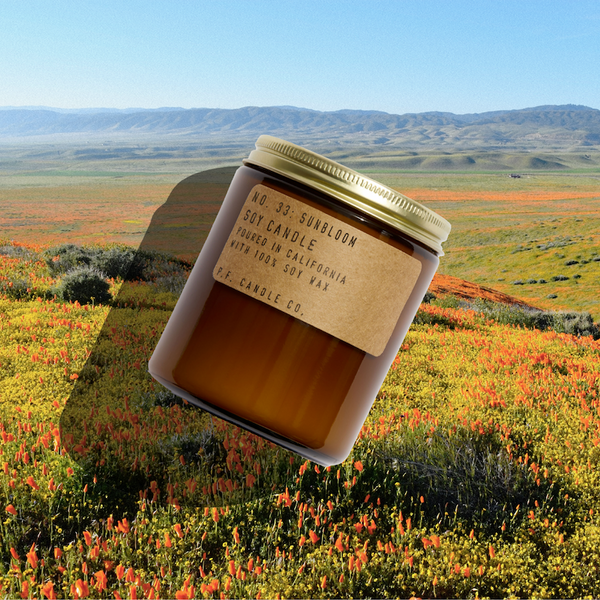 P.F. Candle Co. Wholesale Sunbloom Standard Candle - Lifestyle - Infinite blankets of kaleidoscopic wildflowers, stopping off the highway to revel in the rainbows, bursting bouquets on full display. Notes of golden-rayed lily, yarrow, and tonka bean.